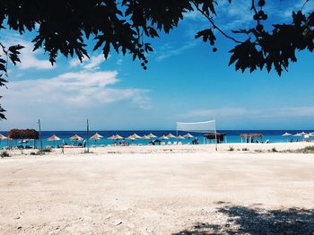 Scenic view of beach against blue sky