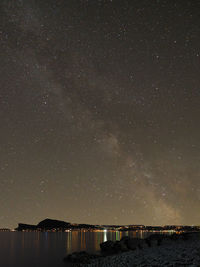 Scenic view of lake against star field at night