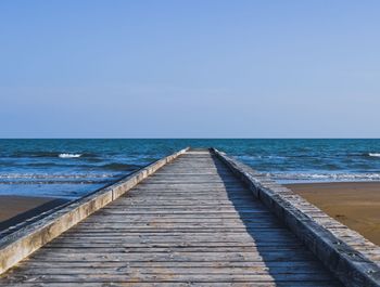 Pier over sea against clear sky