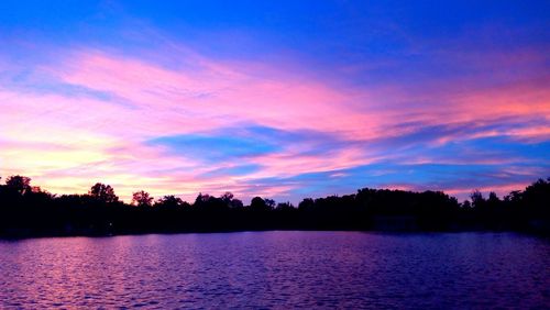 Scenic view of calm lake at sunset