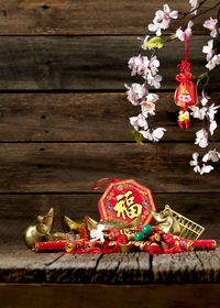 Close-up of red roses hanging on wood