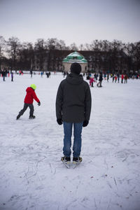 People on snowcapped field during winter