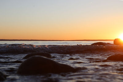 Scenic view of sea against clear sky during sunset