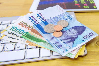 High angle view of money on keyboard over table