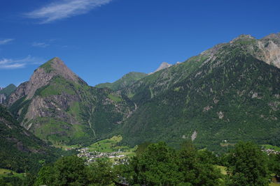 Scenic view of mountains against blue sky