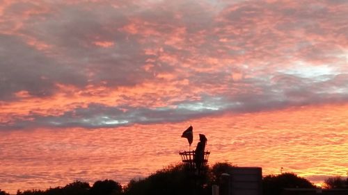 Silhouette man against sky during sunset