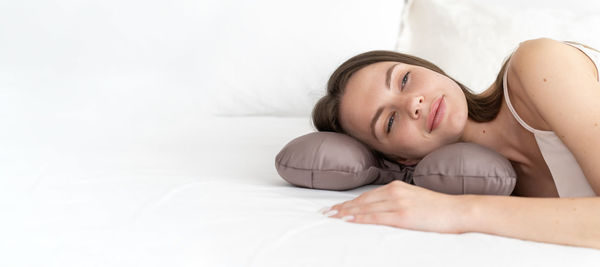Young woman lying on bed at home