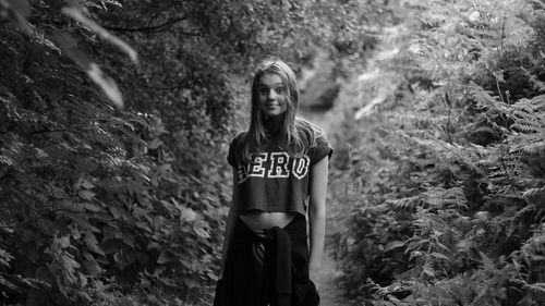 Portrait of surprise woman standing in forest