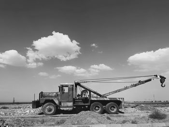 Low angle view of crane against sky