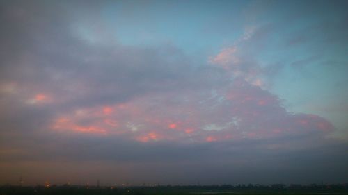 Scenic view of landscape against cloudy sky
