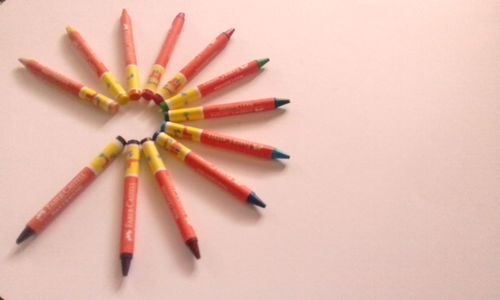 Directly above shot of colored pencils against white background