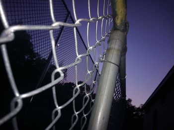 Close-up of barbed wire fence against clear sky