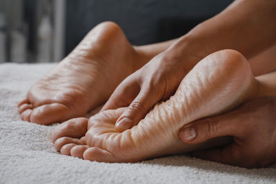 Woman foot spa massage treatment by professional massage therapist in spa resort. wellness, stress