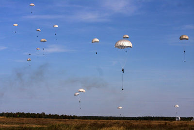 Low angle view of parachutes against sky