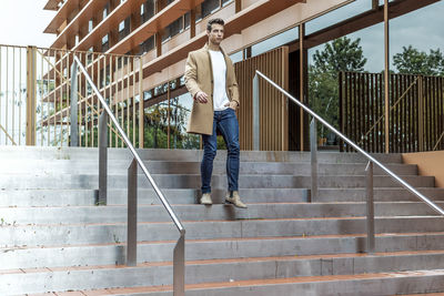 Low section of man walking on staircase