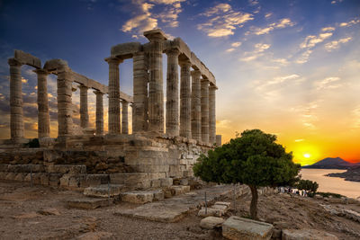 Temple of poseidon against sky during sunset