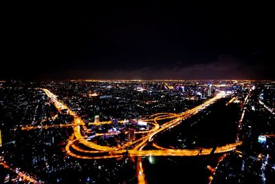 Illuminated cityscape against sky at night