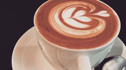 Close-up of coffee cup against black background