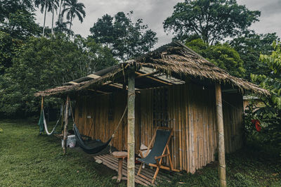 House on field by the caribbean coast against sky