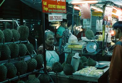 People at market stall for sale