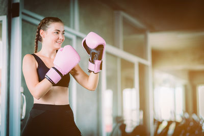 Young woman boxing in gym