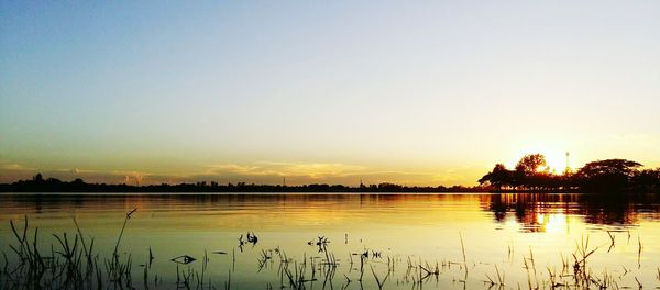 Scenic view of lake against romantic sky at sunset