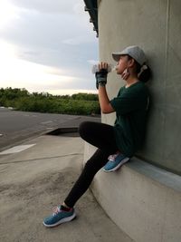 Side view of boy sitting on road