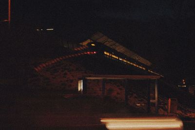 Low angle view of illuminated building against sky at night