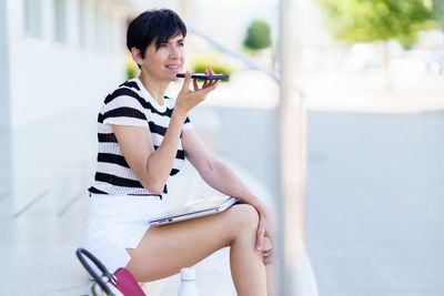 Side view of young woman exercising in gym