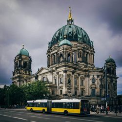 Bus on street against berlin cathedral