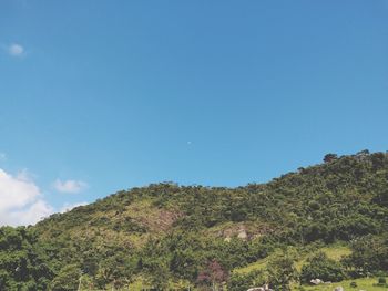 Low angle view of mountain against clear blue sky