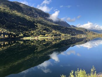 Scenic view of lake and mountains against sky