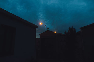 Low angle view of illuminated street light against sky at night