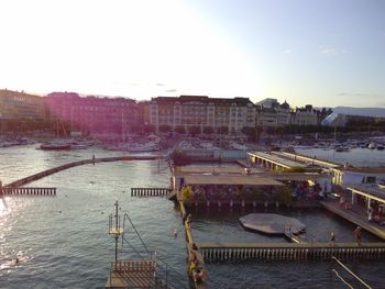 High angle view of boats moored at harbor against clear sky