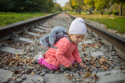 Rear view of girl on railroad track