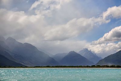 Scenic view of lake and mountains against sky