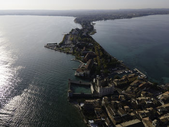 High angle view of sea against sky in city