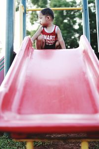 Baby boy on slide at park