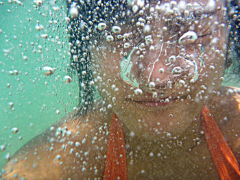 Close-up portrait of woman swimming in sea