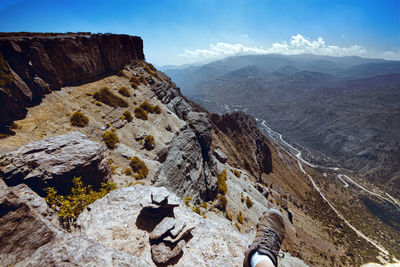 Low section of rocks on mountain against sky