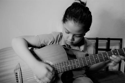 Boy playing guitar at home