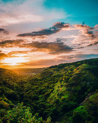 Scenic view of landscape against sky during sunset.