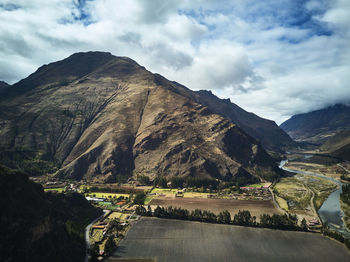 Scenic view of mountains against cloudy sky
