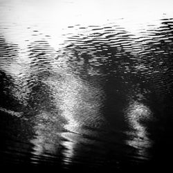 High angle view of raindrops on water