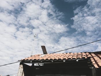 Low angle view of building against cloudy sky