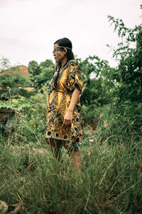 Woman looking away on field