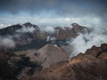 Smoke emitting from volcanic mountain against sky