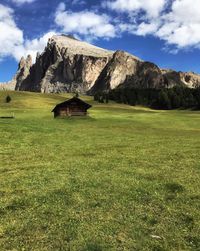 Scenic view of field and mountains against sky