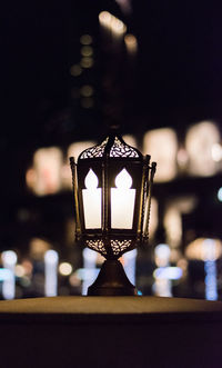 Close-up of illuminated lamp at night