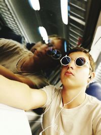 Low angle view of teenage boy sitting in train